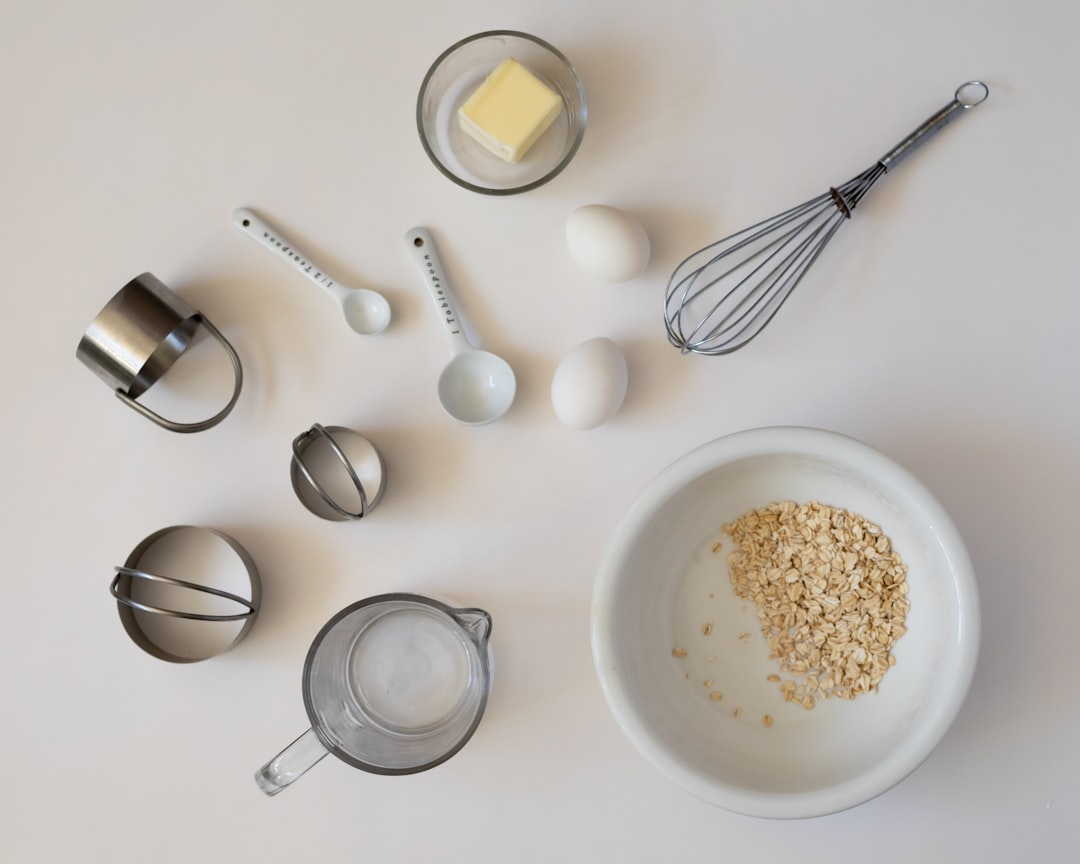 Baking ingredients and measuring tools arranged on a white surface.