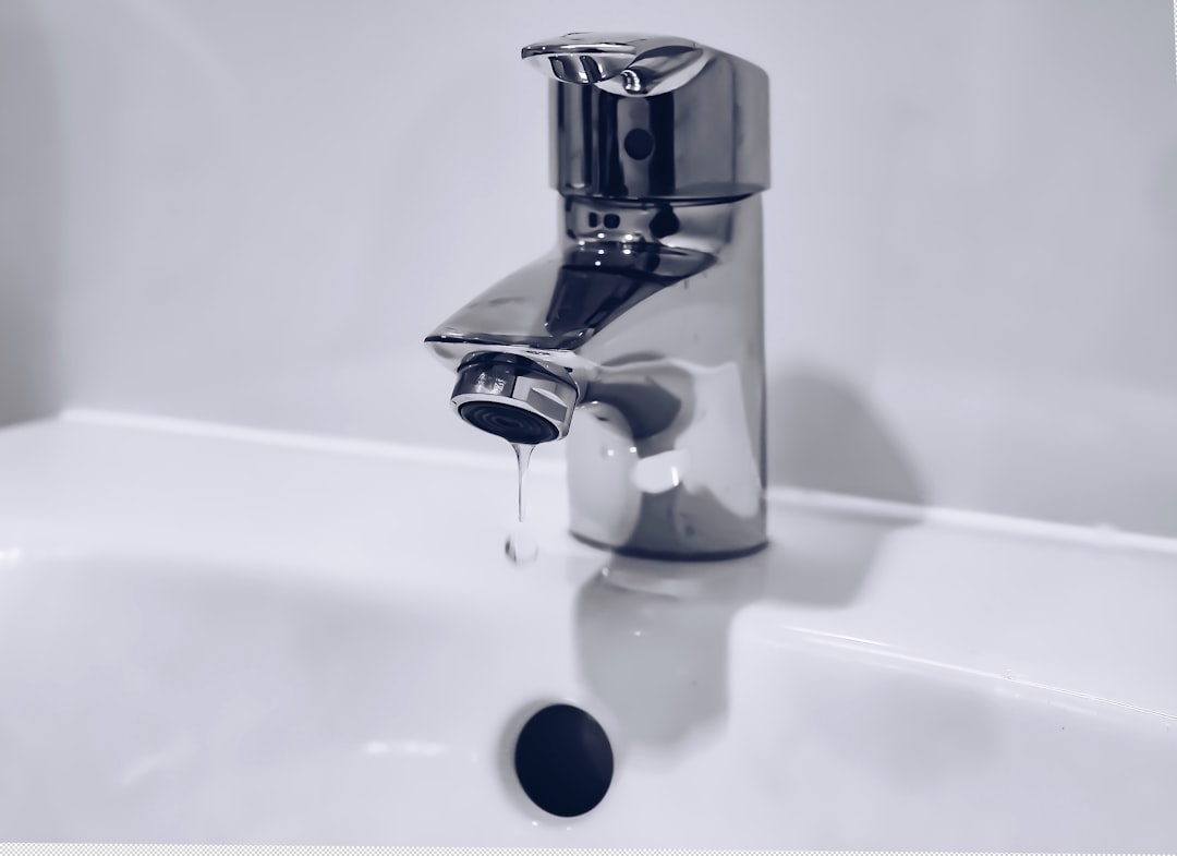 A dripping chrome faucet — symbolizing wealth quietly leaking away unnoticed.