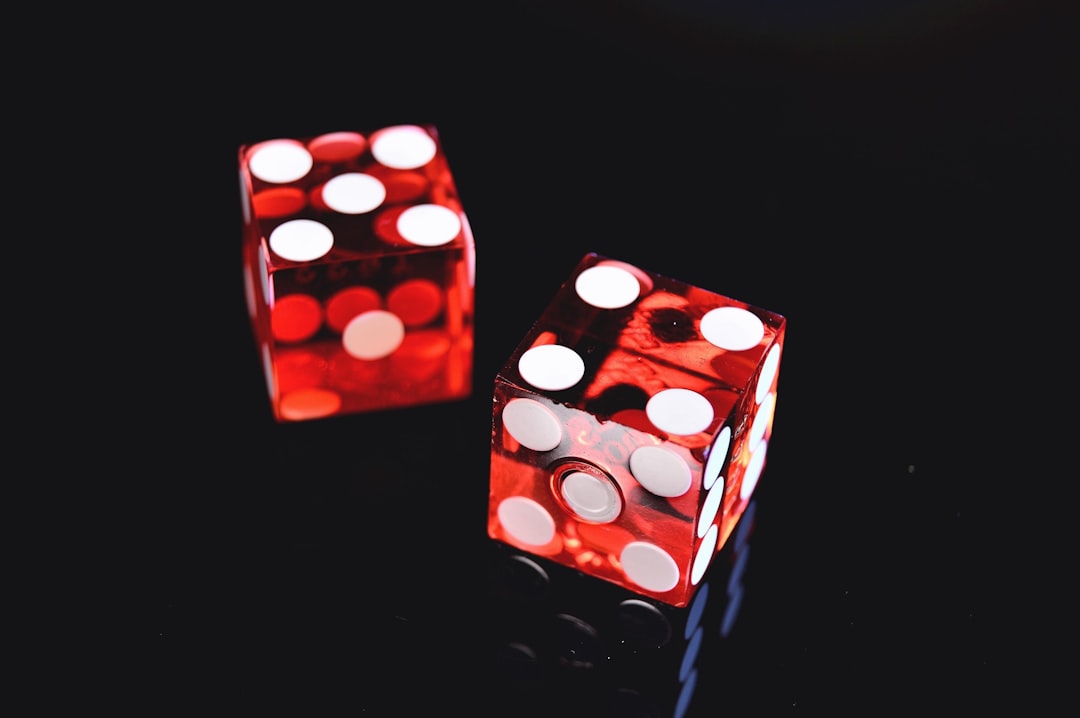 Two red dice on a dark background — symbolizing the risk of leaving investing to chance.