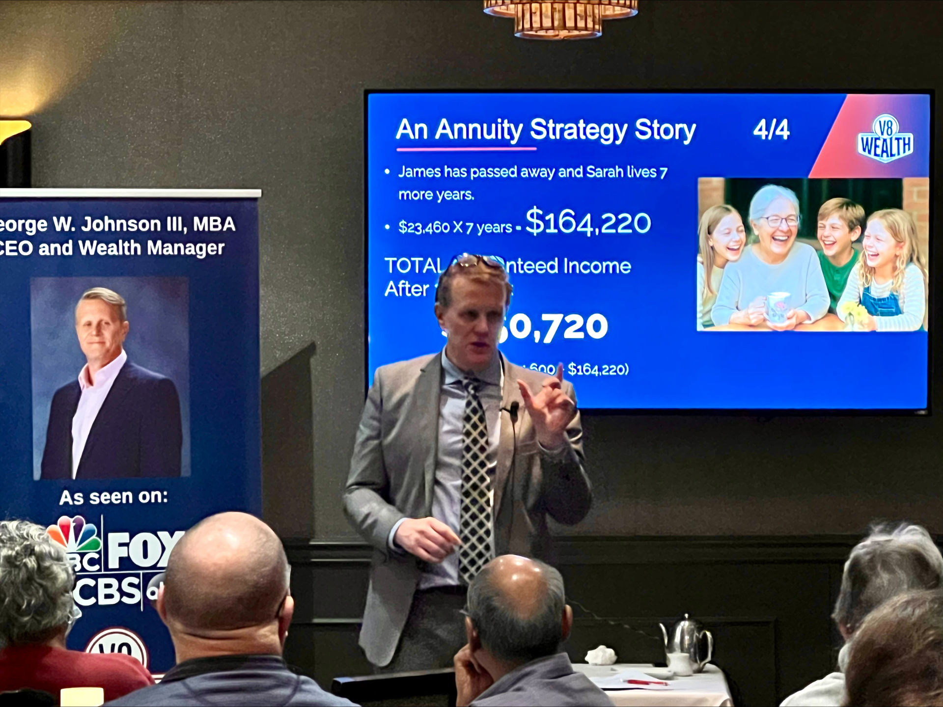 George Johnson presenting an annuity strategy to attendees at a dinner seminar